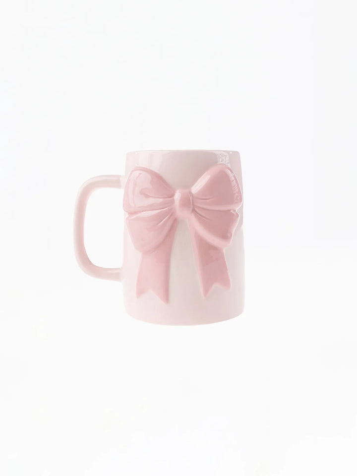 Pink mug with a bow on a white background