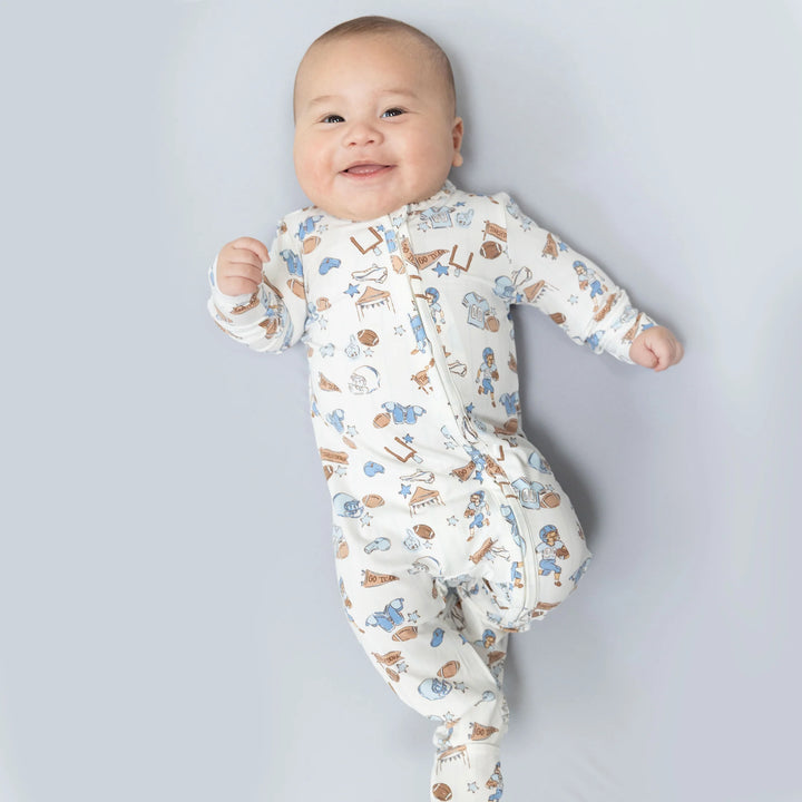 Angel Dear Football Nursery 2-way Zipper Footie worn by a baby in a lifestyle view highlighting the football nursery 2-way design