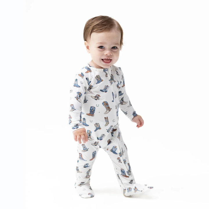 Angel Dear Buckaroo Boots 2-way Zipper Footie worn by a baby in a lifestyle view highlighting the buckaroo boots 2-way design