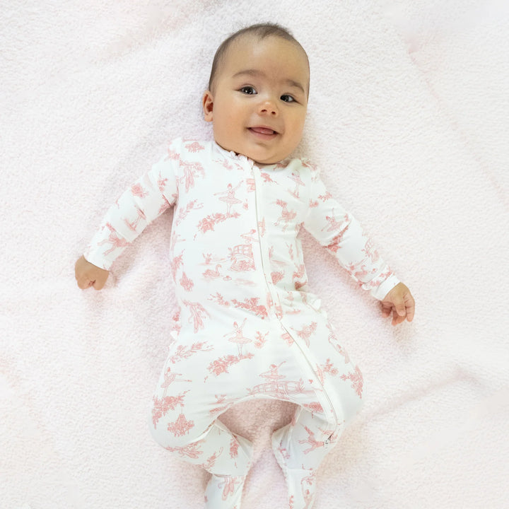 Angel Dear Ballet Toile 2-way Ruffle Back Zipper Footie worn by a baby in a lifestyle view highlighting the ballet toile 2-way design