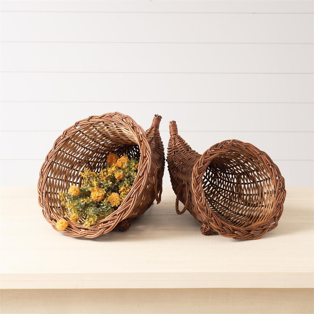 Two wicker cornucopias with decorative elements on a light background