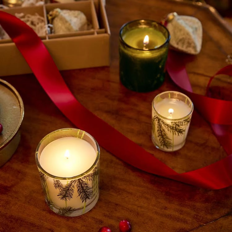 Frasier Fir pine needle votive candle glowing in clear etched glass
