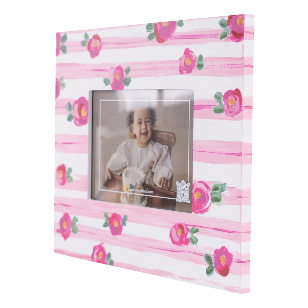 PINK STRIPE WITH FLORAL DETAIL PICTURE FRAME ON WHITE BACKGROUND