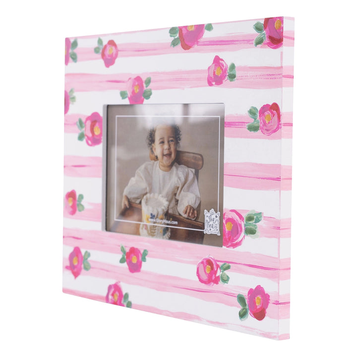 PINK STRIPE WITH FLORAL DETAIL PICTURE FRAME ON WHITE BACKGROUND