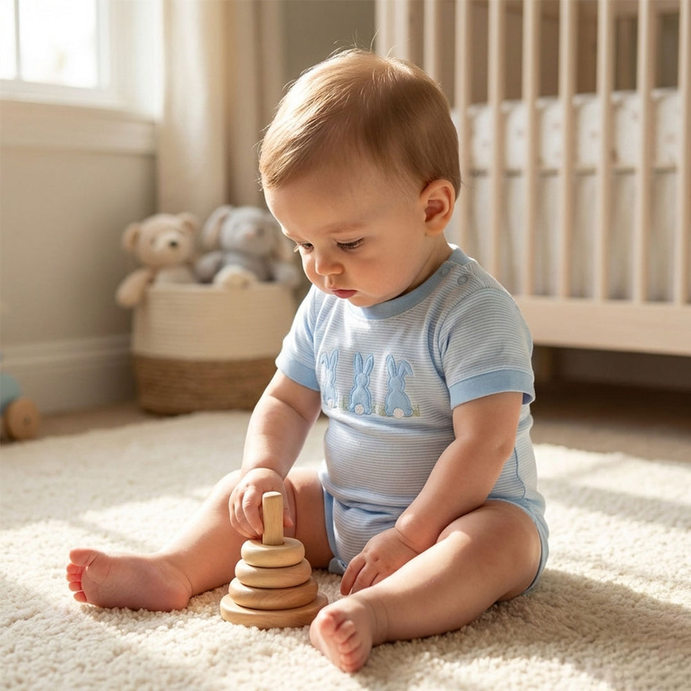 Baby playing with a wooden toy in a nursery