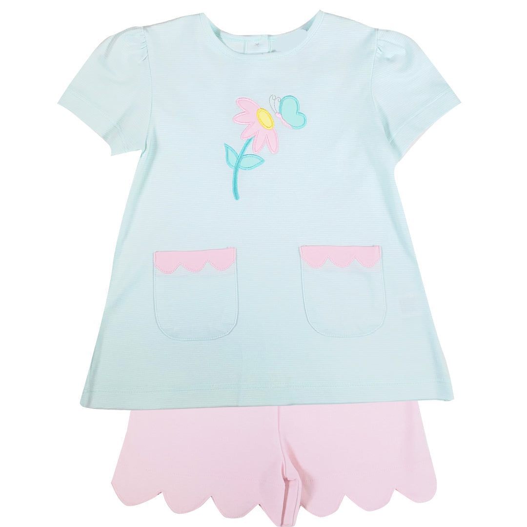 Light blue top with floral & butterfly design and pink shorts on a white background