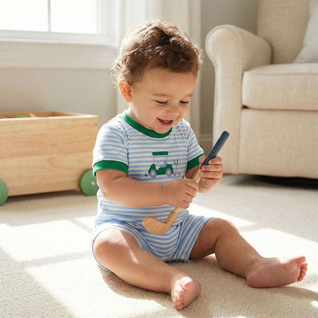 Child playing with wooden toys on a carpeted floor
