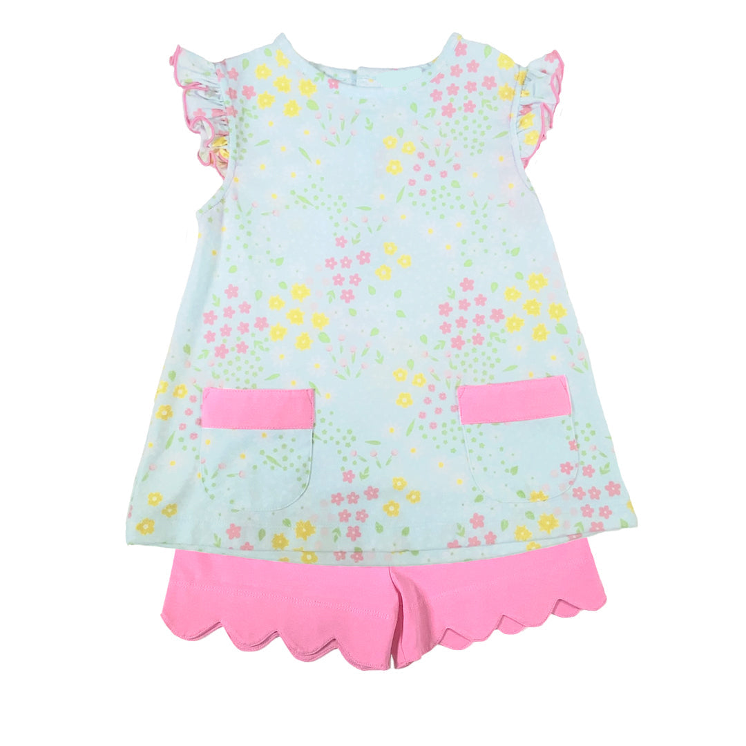 Children's top with floral pattern and pink accents and pink shorts on a white background