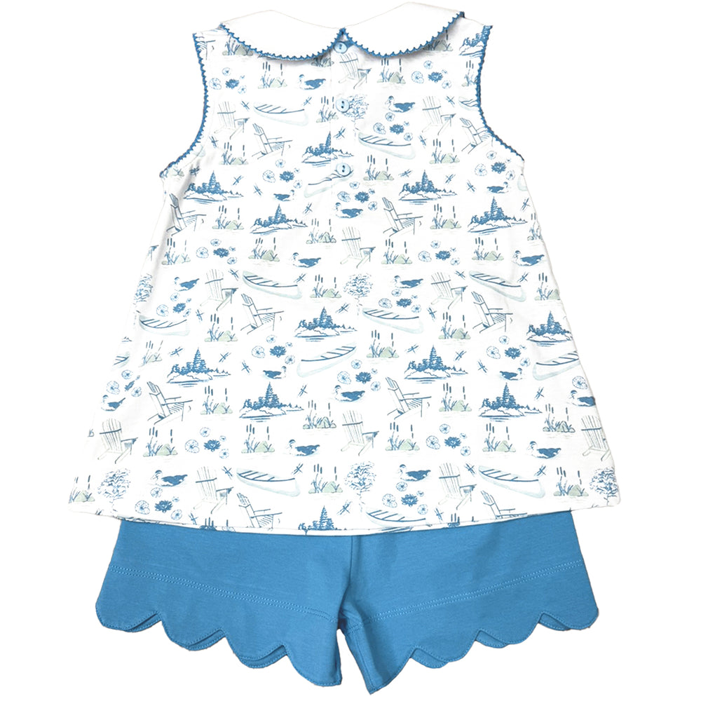 Children's outfit with a blue toile patterned top and blue shorts on a white background