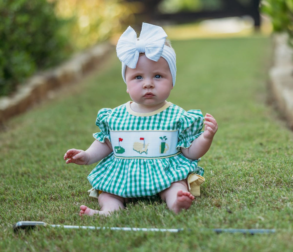 LITTLE GIRL WEARING GREEN GINGHAM SMOCKED GOLF BUBBLE