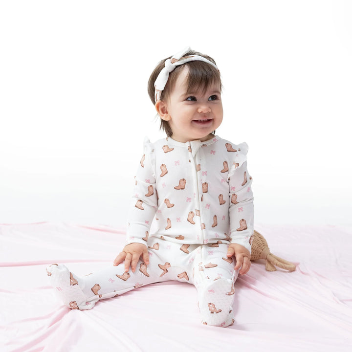 Angel Dear Mini Cowgirl Boots 2-way Ruffle Sleeve Zipper Footie worn by a baby in a lifestyle view highlighting the mini cowgirl boots 2-way design