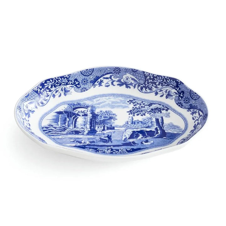 Blue and white decorative plate with scenic design on a white background