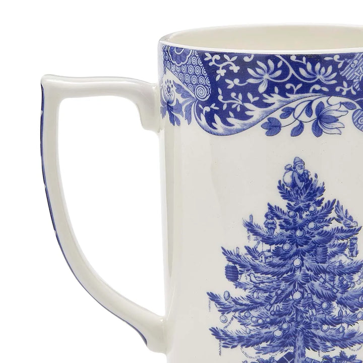 Mug with blue floral pattern and Christmas tree design on a white background