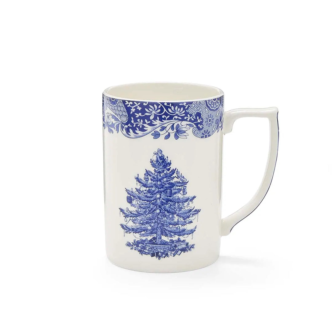 White mug with blue floral pattern and pine tree design on a white background