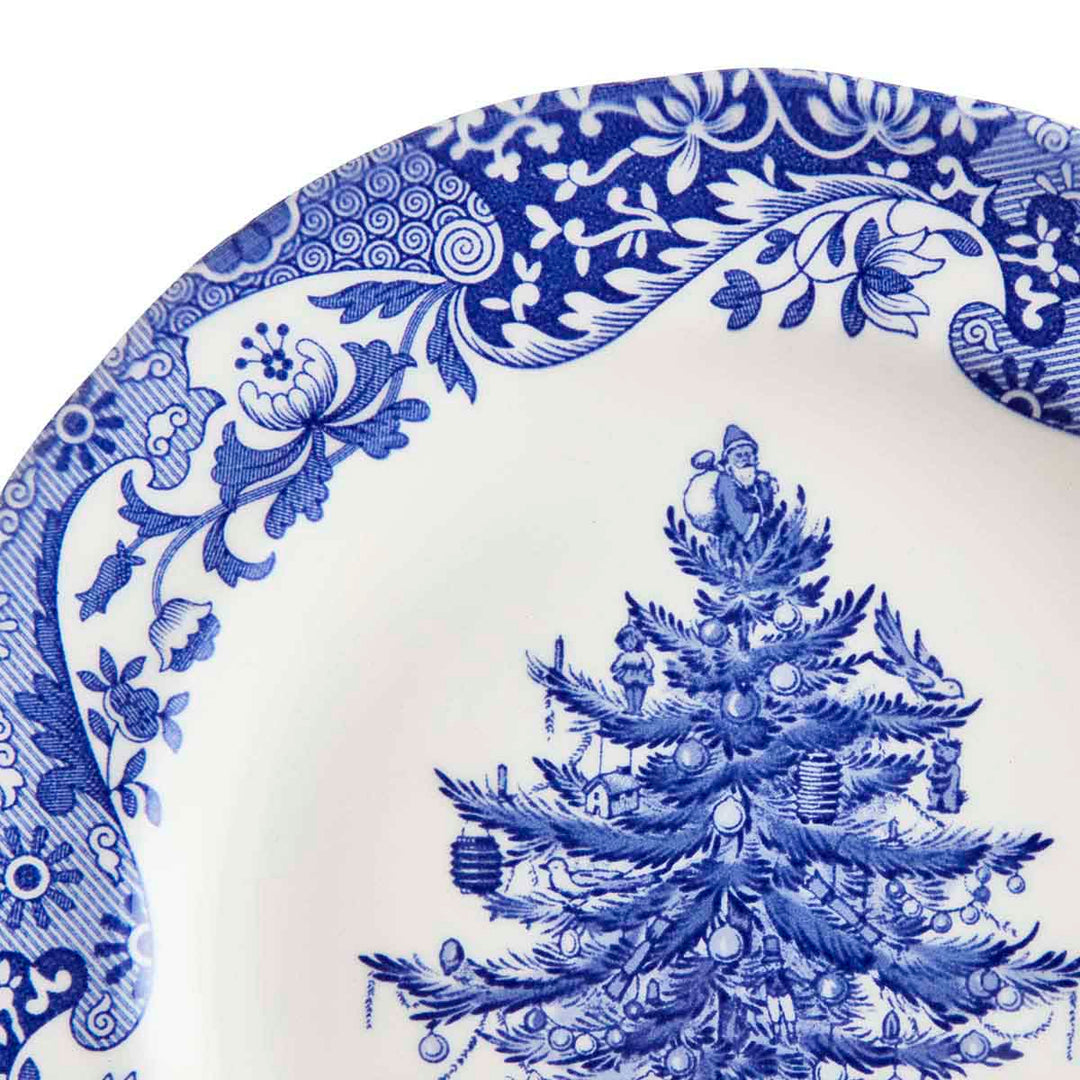Blue and white decorative plate with a Christmas tree design