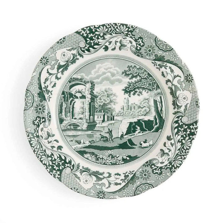 Decorative plate with green and white scenic design on a white background