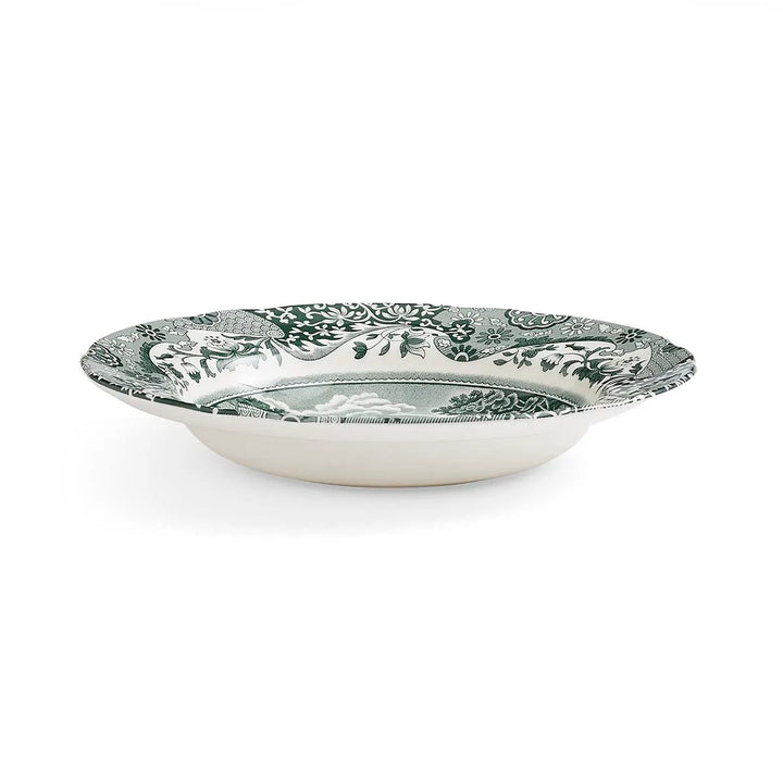 Decorative ceramic bowl with green floral pattern on a white background