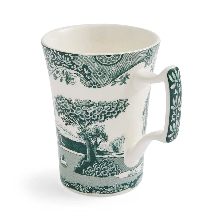 Ceramic mug with green and white nature-themed design on a white background