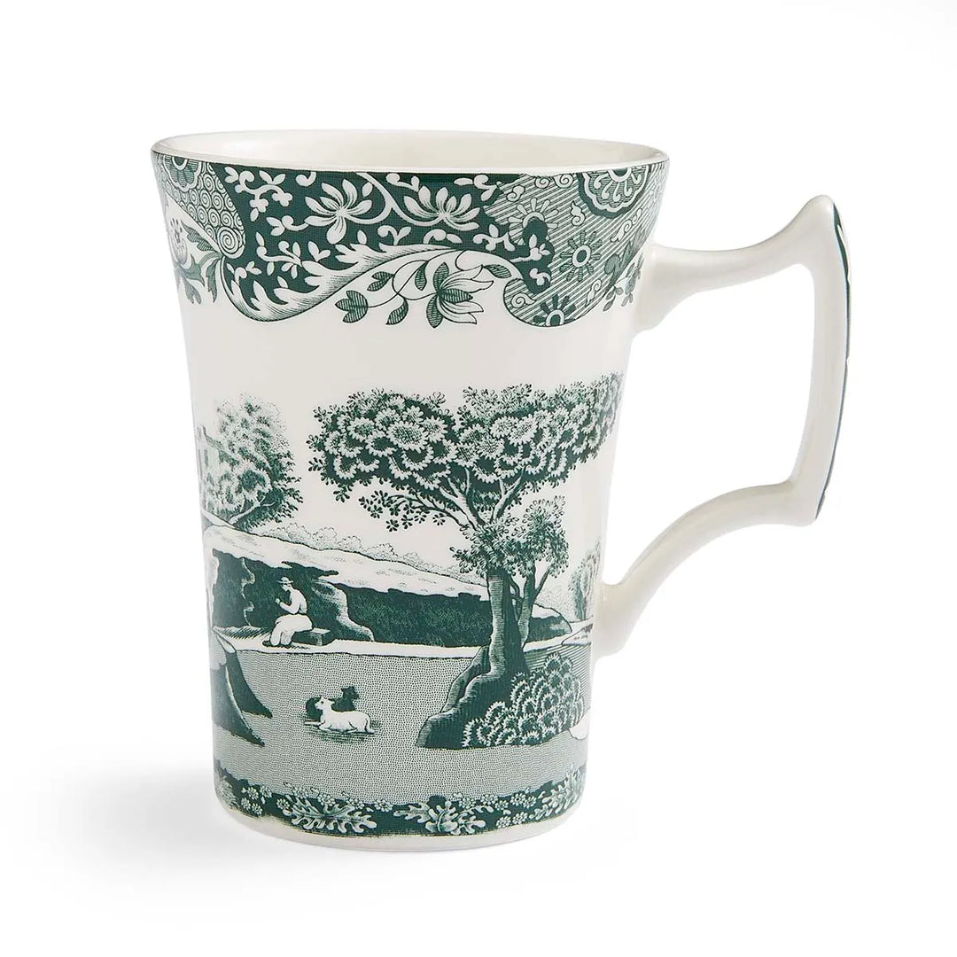 White mug with green floral and landscape design on a white background