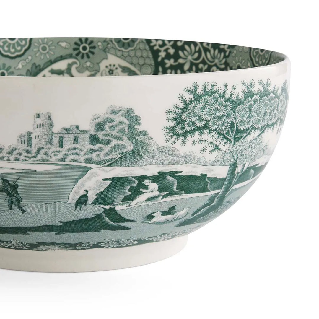 Ceramic bowl with green and white landscape design on a white background