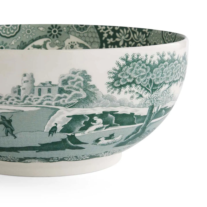 Ceramic bowl with green and white landscape design on a white background