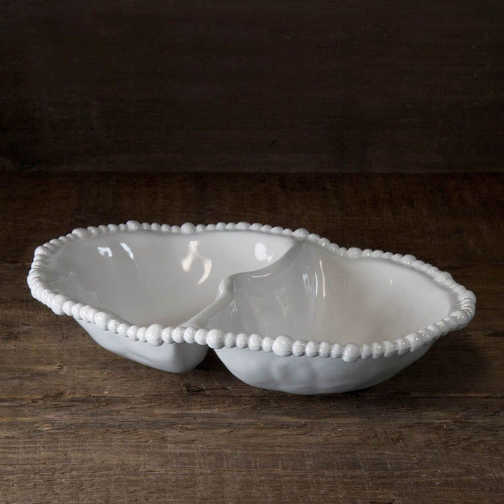 A white, melamine Alegria Double Dip serving dish with a decorative rim, displayed on a wooden surface.