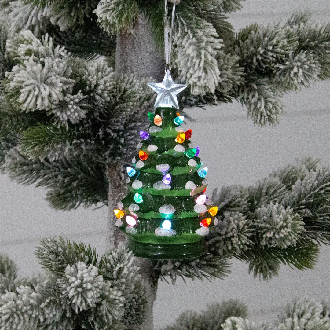 Decorative Christmas tree ornament with colorful lights hanging on a tree.