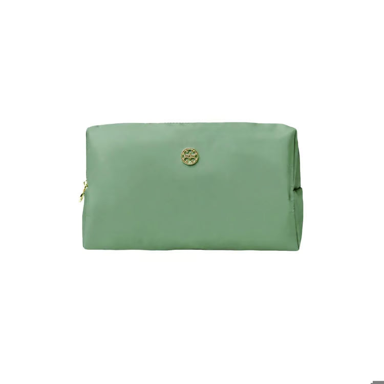 A sage green zippered pouch with a small gold-tone circular logo emblem on the front, set against a plain white background.