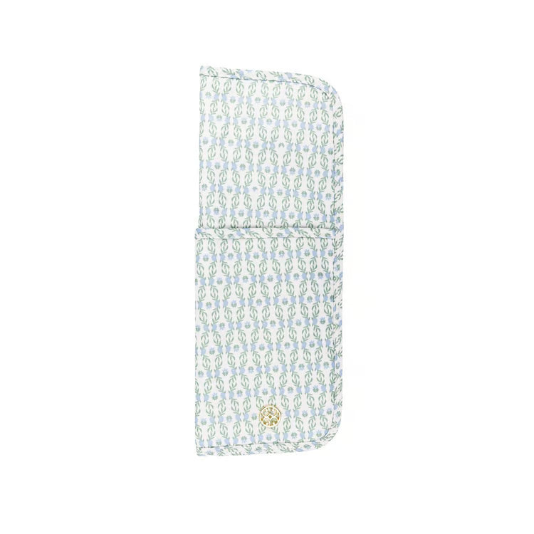 A light blue and white patterned fabric pouch with a small gold button closure, shown on a plain white background.