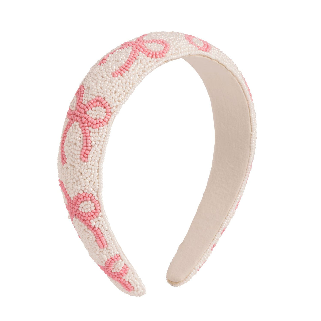 Beaded headband with pink bow pattern on a white background