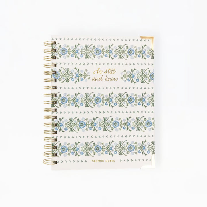 Notebook with floral design and text on a white background