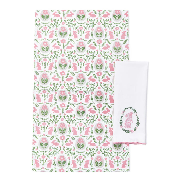 Floral and animal patterned towel with a matching white towel featuring a logo on a white background