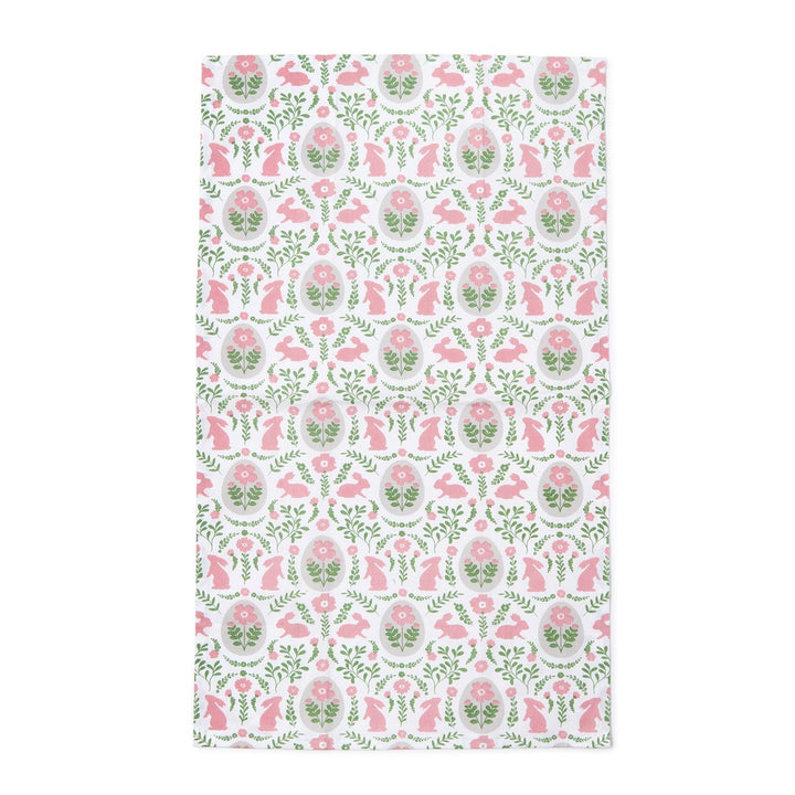 Floral and animal patterned fabric swatch with pink and green colors on a white background