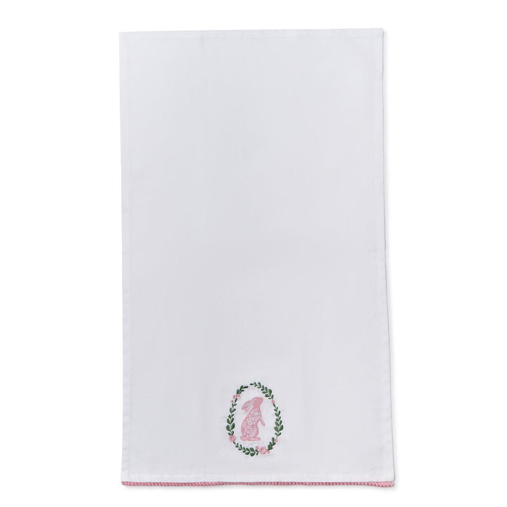White towel with embroidered design on a white background