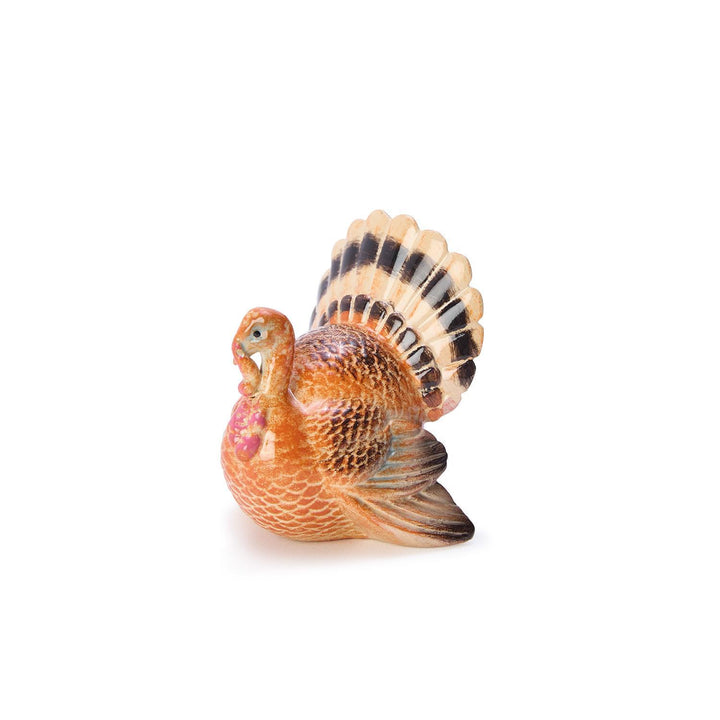 Small decorative turkey figurine on a white background