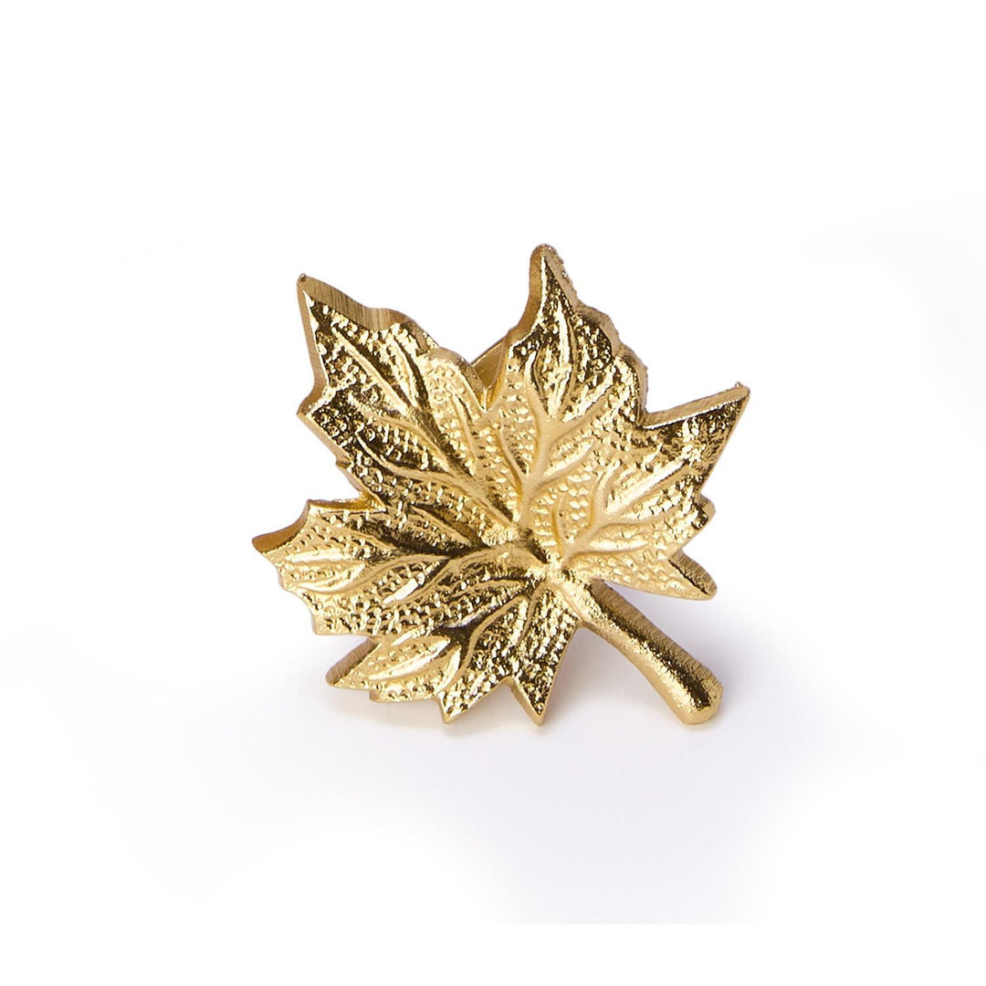 Gold maple leaf brooch on a white background