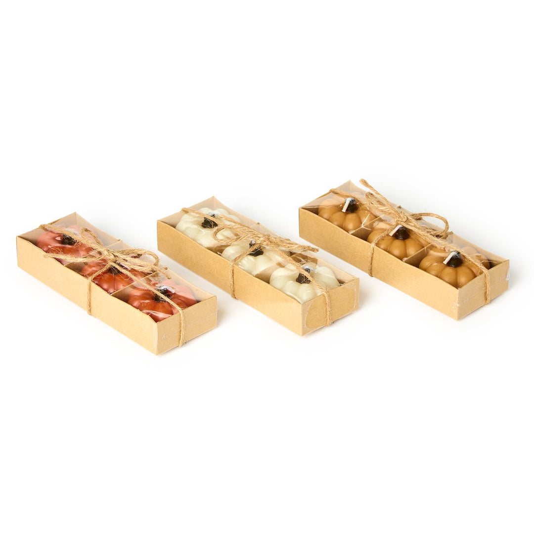 Four gold gift boxes with small items inside on a white background