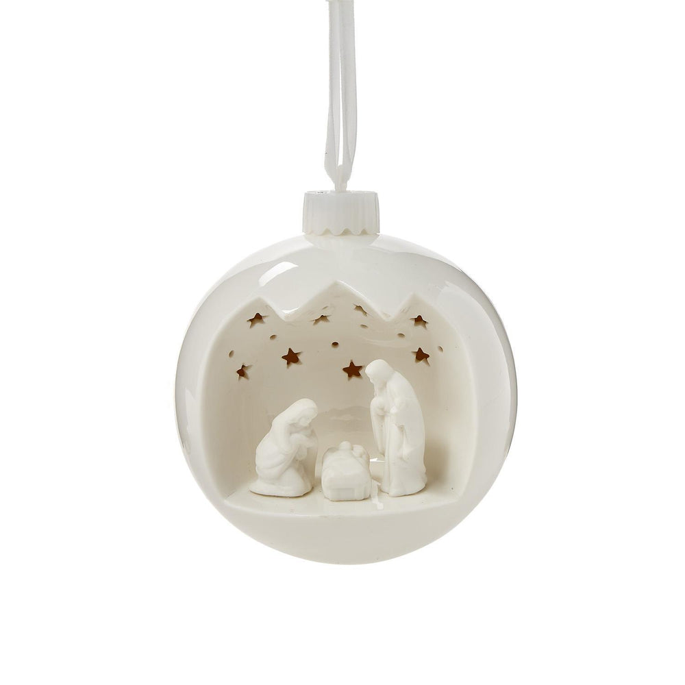 White ceramic nativity scene ornament with starry background on a white background