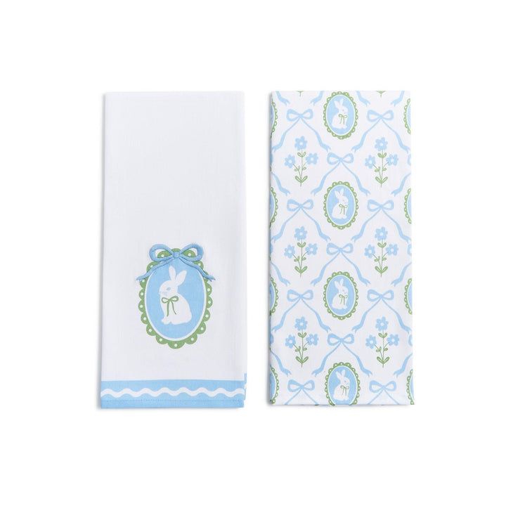 Two dish towels with bunny and floral patterns on a white background