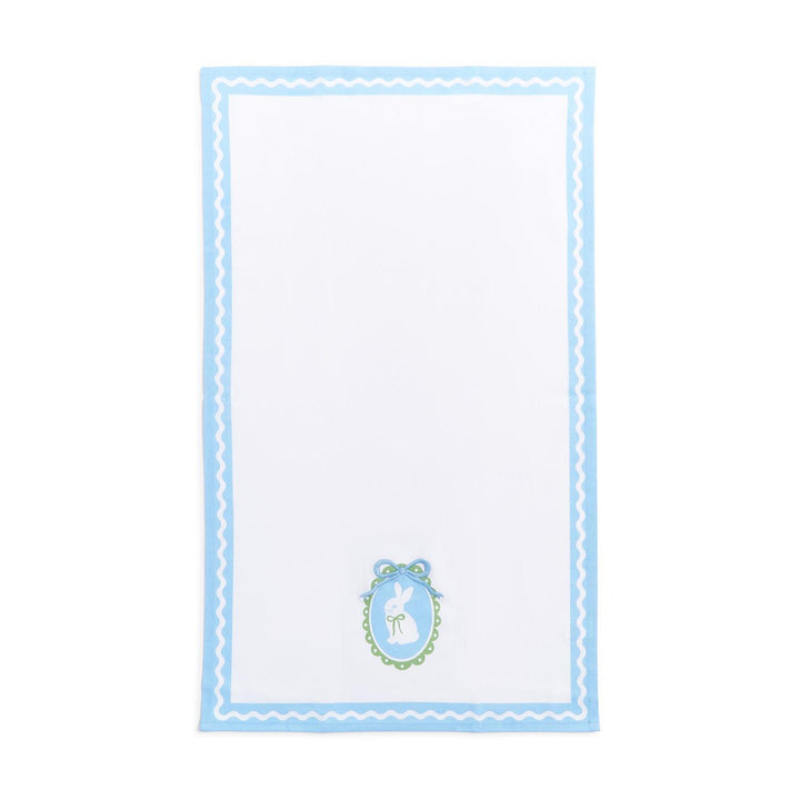 White napkin with blue border and decorative emblem on a white background