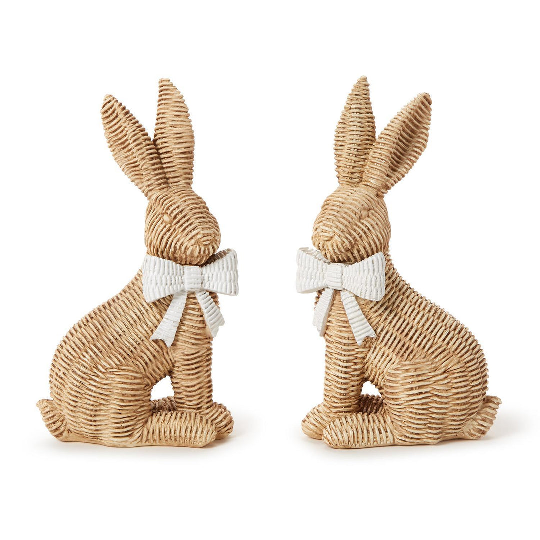 Two woven rabbit figurines with white bows on a white background