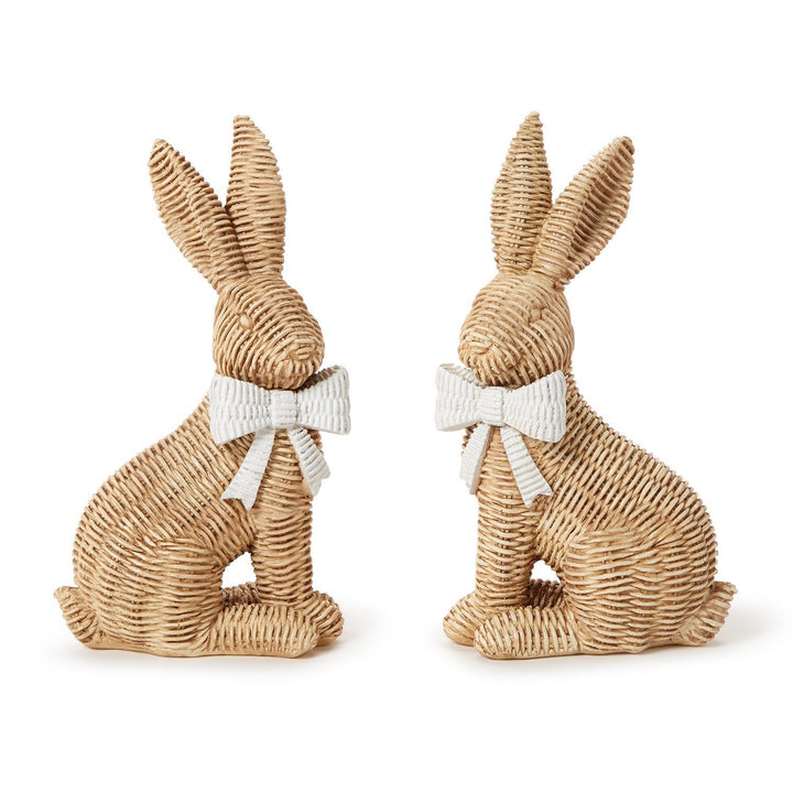 Two woven rabbit figurines with white bows on a white background
