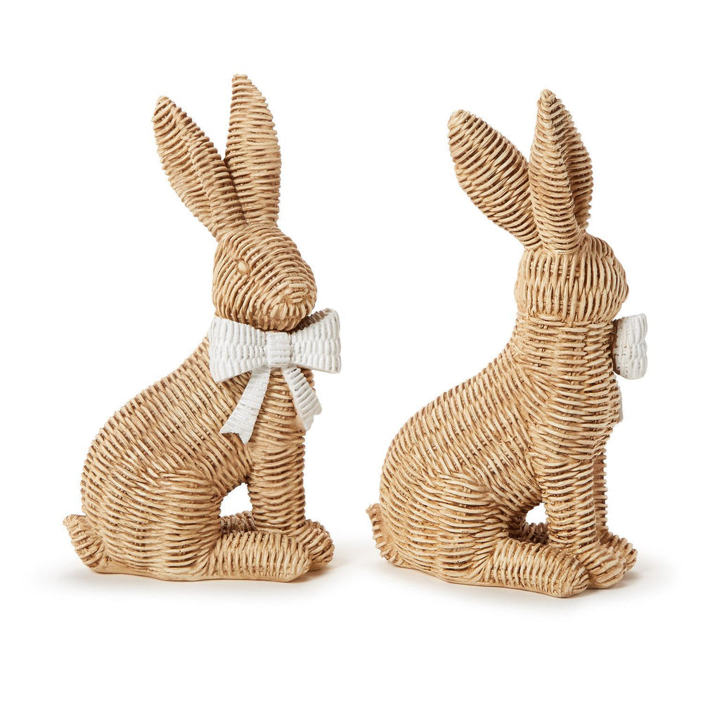 Two woven rabbit figurines with white bows on a white background