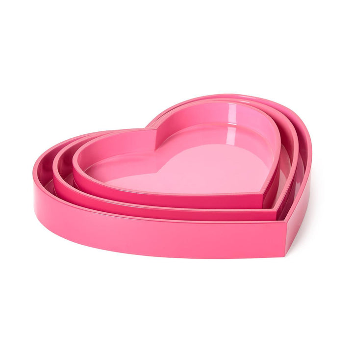 Set of pink heart-shaped trays on a white background