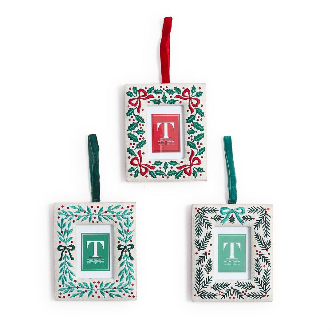 Set of three decorative Christmas ornaments with floral patterns and letter 'T' on a white background.