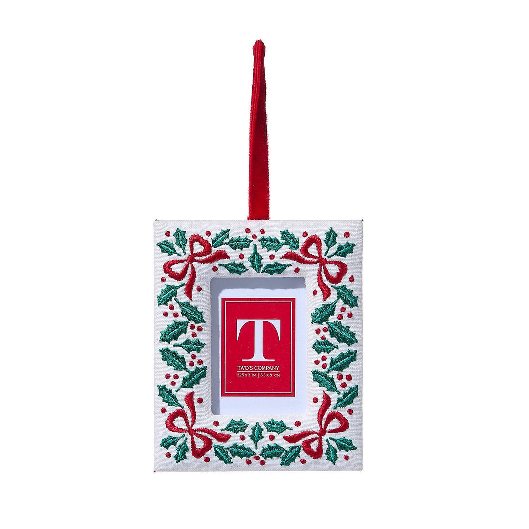 Decorative Christmas frame ornament with red 'T' logo on a white background