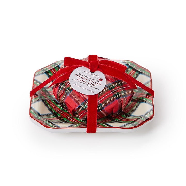 Red and green plaid hamper with a red ribbon on a white background