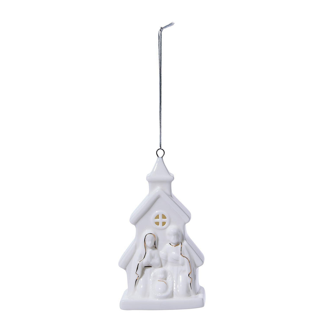 White ceramic Christmas village house ornament on a white background