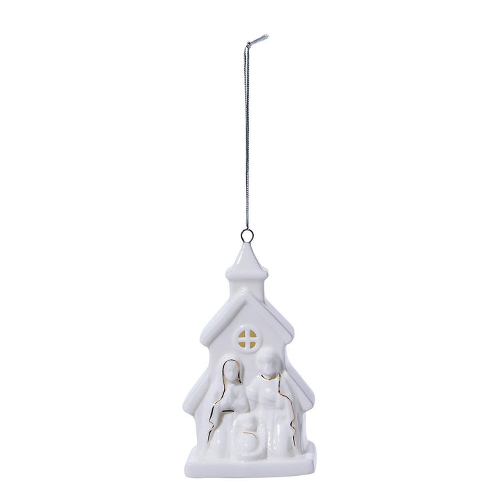 White ceramic Christmas village house ornament on a white background