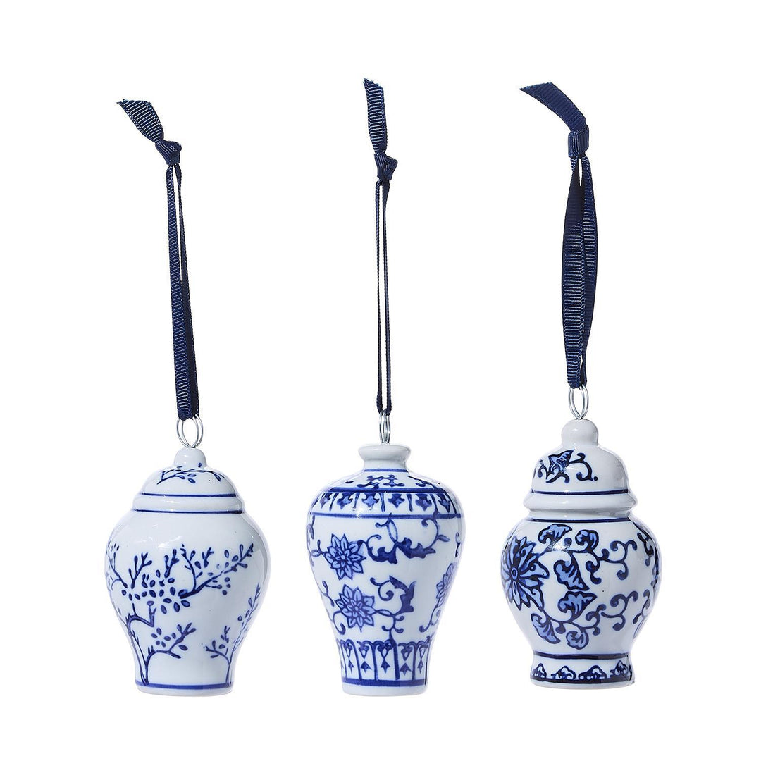 Three blue and white ceramic ornaments with floral patterns on a white background